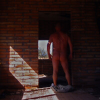 Nude male poses in abandoned house
